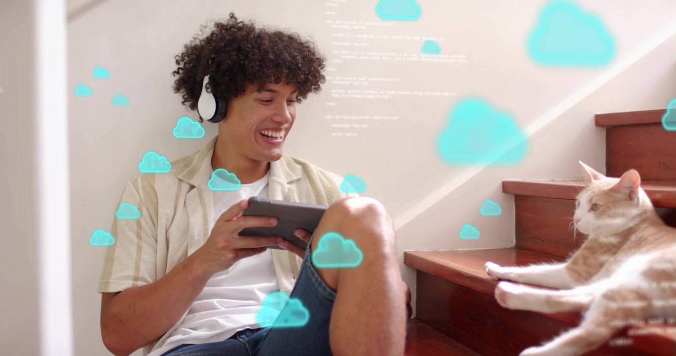 Headphone-wearing man tapping tablet on stairs activating cloud computing visuals and petting cat