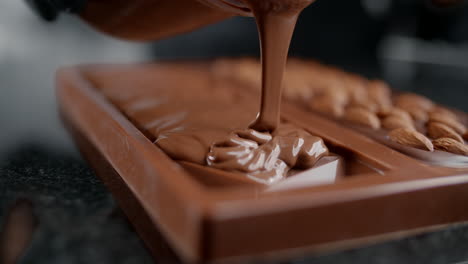 making chocolate bar with almonds