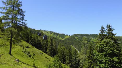 Steep-rope-way-leading-up-a-mountain-through-a-forest-in-the-Alps-in-Lofer,-Austria