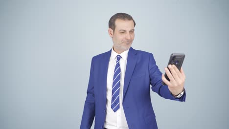 Video-of-businessman-making-video-call-on-phone.