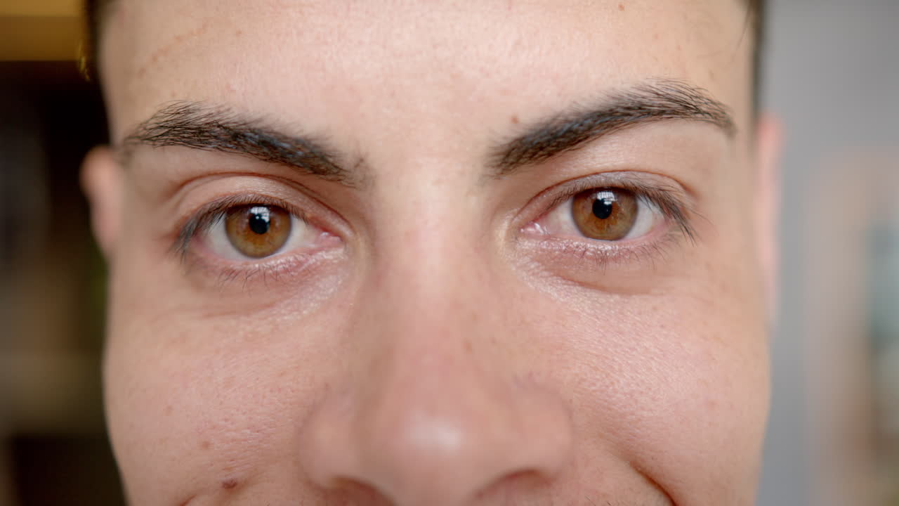 Close-up of person's face with brown eyes, focusing on expression