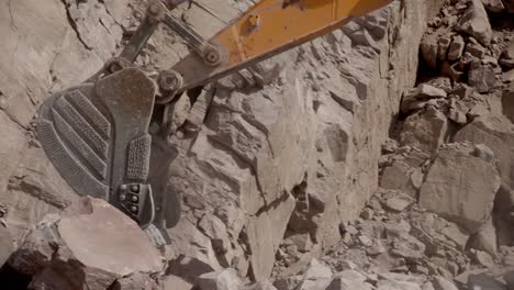 wheel loader loading and dumping rocks in a stone quarry