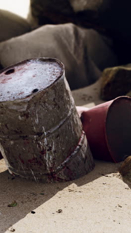 rusty barrels on a sandy beach