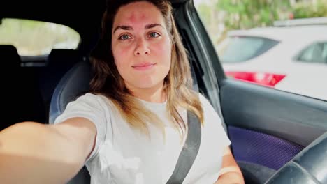 smiling woman vlogging in car on sunny day