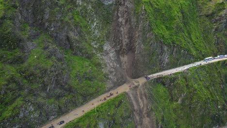 Aerial-view-of-landslide-blocking-a-highway-through-steep-hills-in-Lima,-Peru