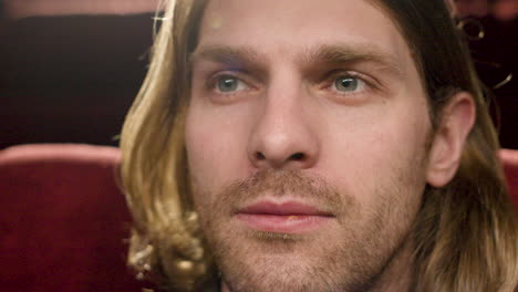 Close-Up-View-Of-Blond-Man-Watching-A-Movie-In-The-Cinema-1