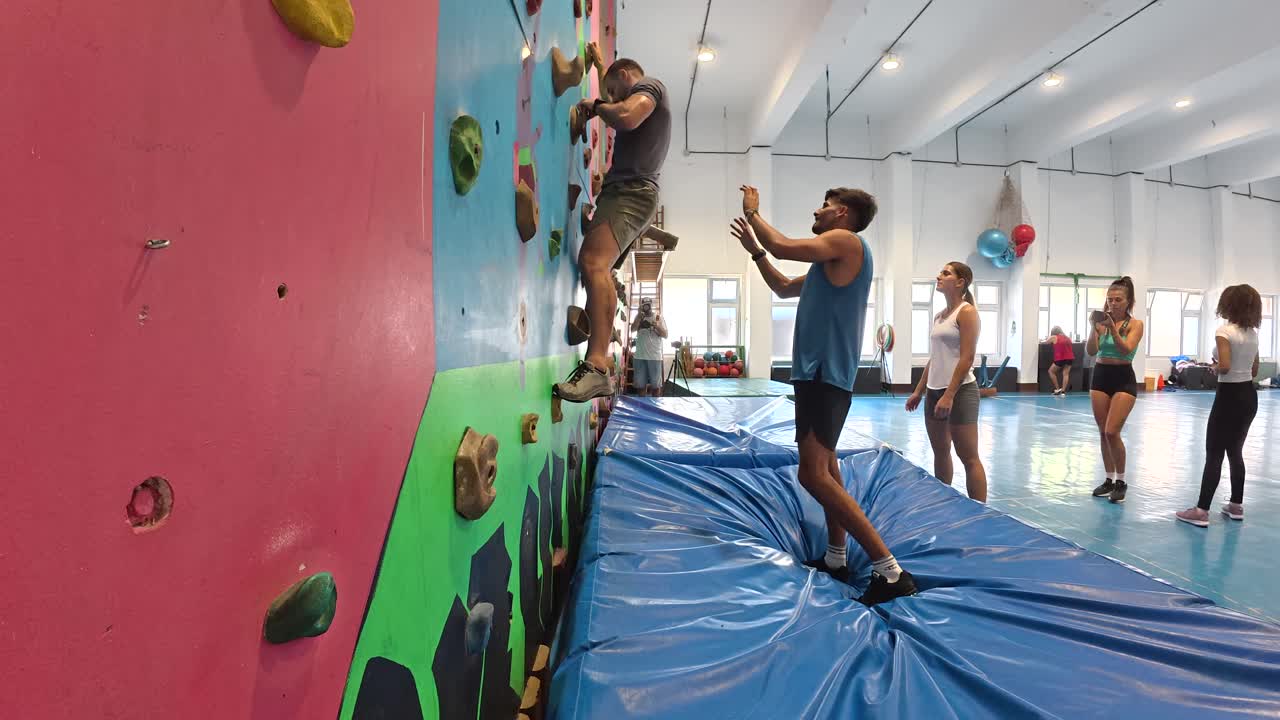 People rock climbing in an indoor gym
