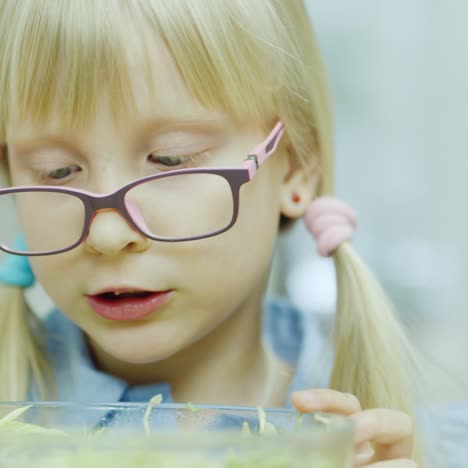 A-Funny-Girl-Eats-A-Salad-From-A-Large-Bowl-Next-To-Her-Grandmother-2