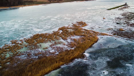 large frozen and flooded river, nordic winter scene, aerial