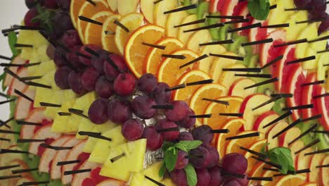 a pyramid of sliced tropical fruits at a wedding buffet