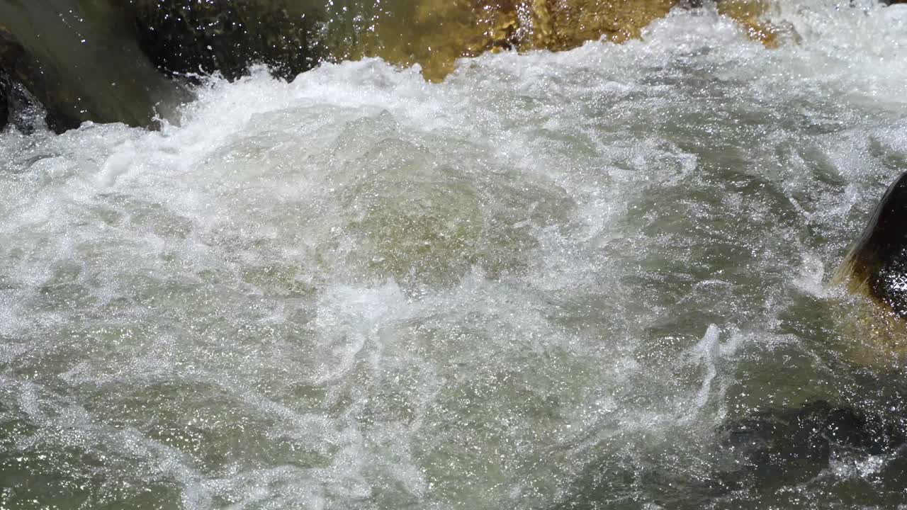 Water is flowing through a mountain torrential river.