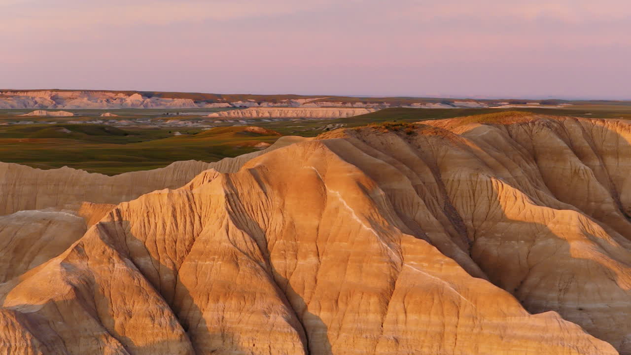 Fiery Skies Over Rugged Badlands Peaks Captured in Stunning Aerials