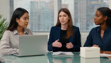 confident businesswoman leading discussion in office meeting
