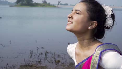 A-bharatnatyam-dancer-displaying-a-classical-bharatnatyam-pose-in-the-nature-of-Vadatalav-lake,-Pavagadh