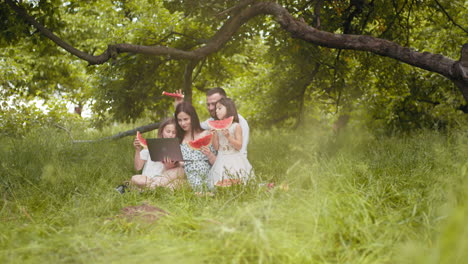 family picnic in a park with watermelon