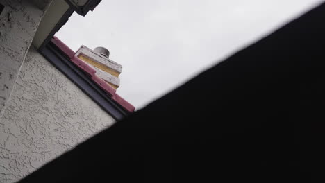 view of chimney in the rain from apartment building balcony