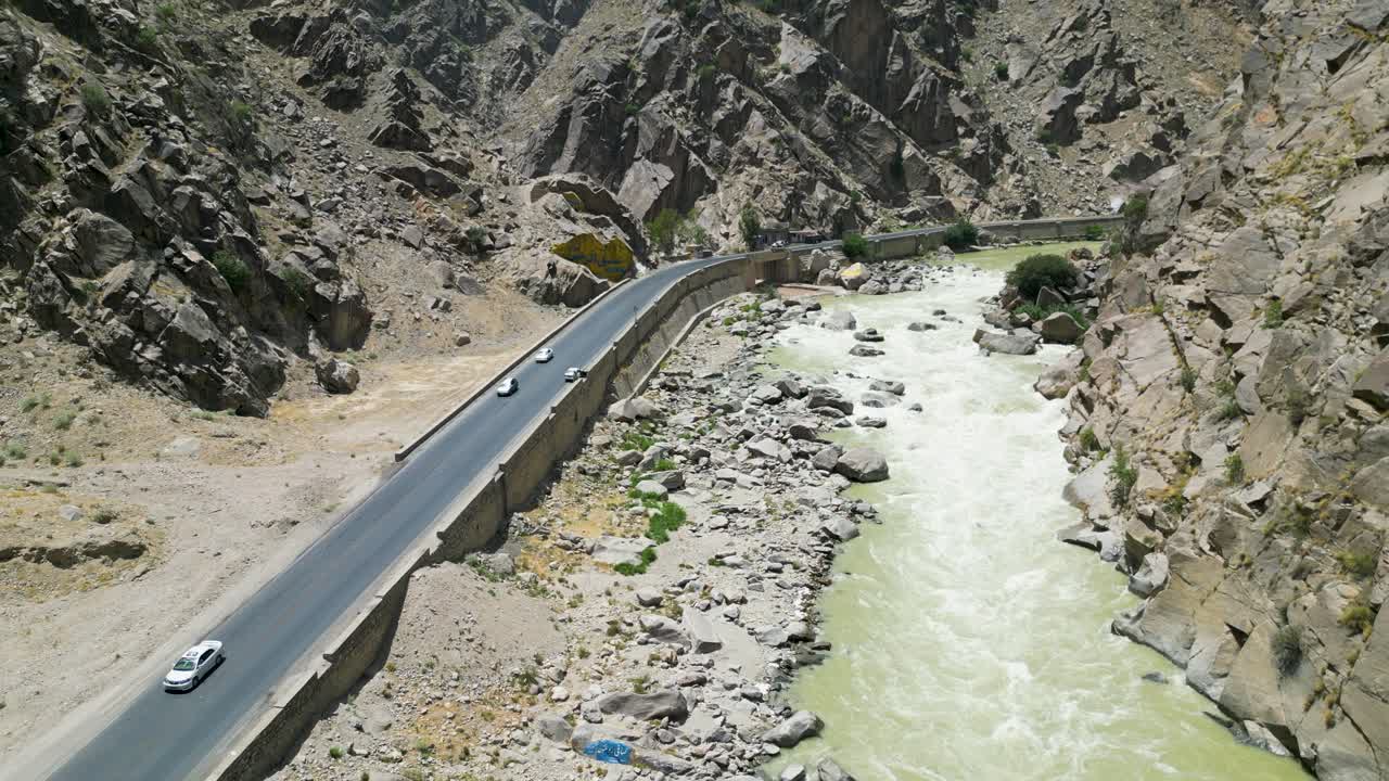 Drone Shot of KabuL River and Highway Road Traffic Under Shiwari Mountain, Afghanistan