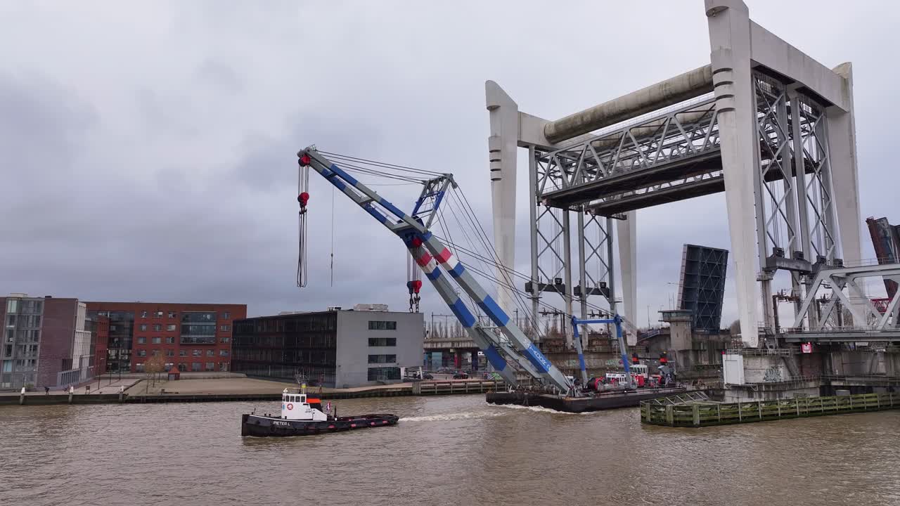 Industry crane pulled through and beneath the towering railway bridge