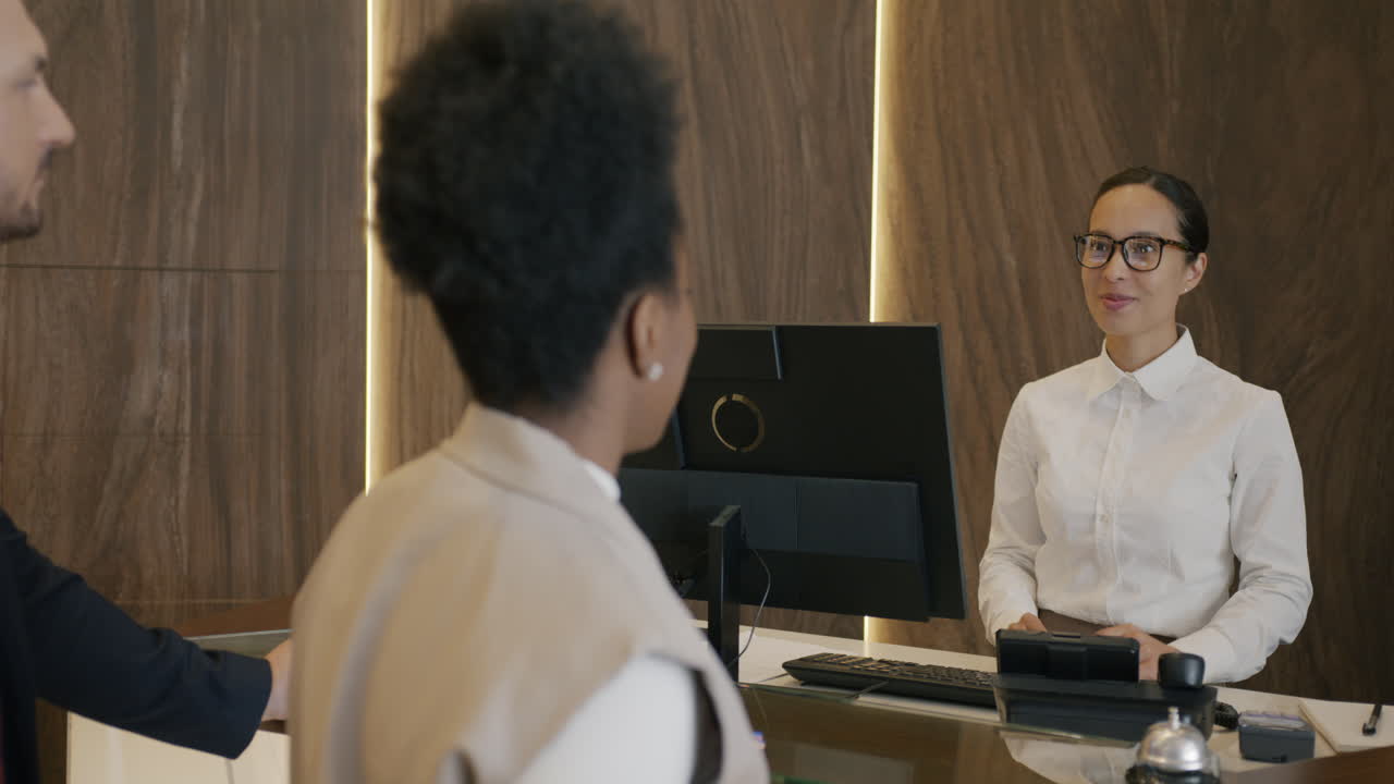 Hotel Receptionist Assisting Guests