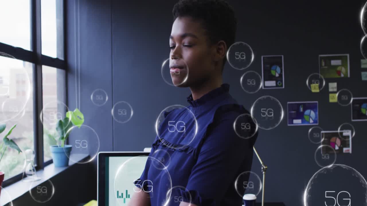 Animation of multiple 5g text banner over african american woman looking out of window at office