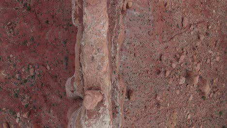 Dramatic-aerial-drone-down-angle-moving-along-Utah-rock-cliffs-in-morning-light