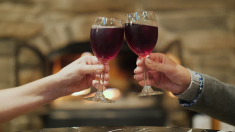 Toasting-With-Red-Wine-by-Fire