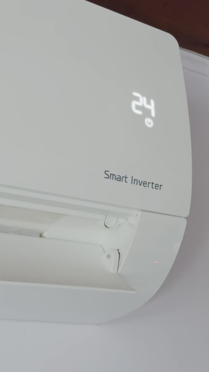 Vertical handheld view of domestic climate unit adjusting heat setting. Home appliance concept for energy efficiency, comfort, and smart living