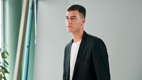 man in black suit and white t-shirt studio portrait