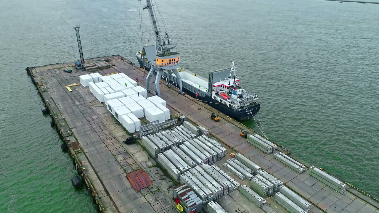 Cargo Ship at Dock Loading Heavy Containers with Large Crane in port operated by Terrabalt