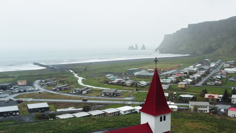 Aerial-drone-shot-of-local-Church-in-Vík-í-Mýrdal,-South-Iceland