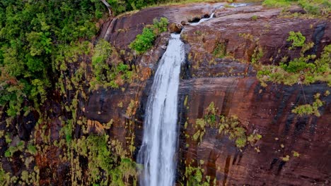 experience the mystical allure of diyaluma falls as captured by aerial drone footage on a foggy day