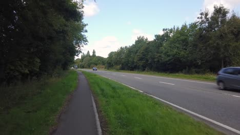 cycling from oxford next to a less busy road on a cloudy day, handheld.