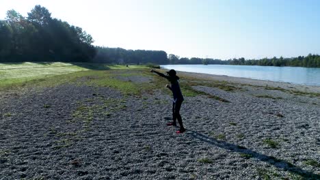 drone shot of young attractive black female doing sports outdoors