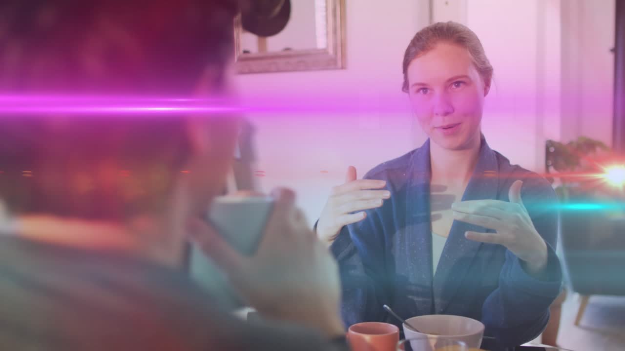 Speaker starting breakfast chat with gestures, marketing overlays sweeping across frame