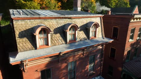 Old-red-brick-building-with-ornate-architecture-and-slate-roof