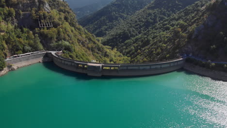 aerial view of a dam and reservoir in a mountain valley