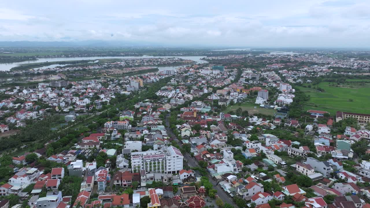 Hoi an with rivers, houses, and green fields on a cloudy day, aerial view