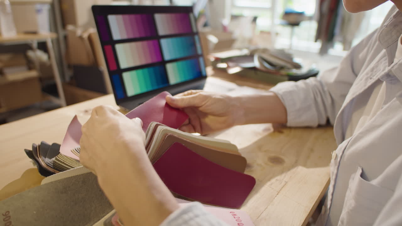 Female Designer Working with Color and Material Palettes in Studio