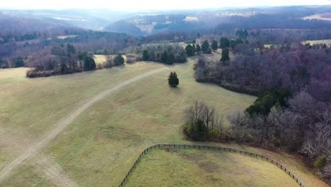 Trucking-pan-of-a-beautiful-horse-farm-in-Frankfort-Kentucky-with-hazy-blue-background-and-sprawling-forests