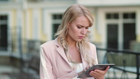 closeup woman using tablet computer at street. businesswoman working on touchpad