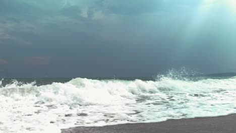 Sea-waves-and-sun-rays-through-cloudy-sky-in-Sozopol,-Bulgaria