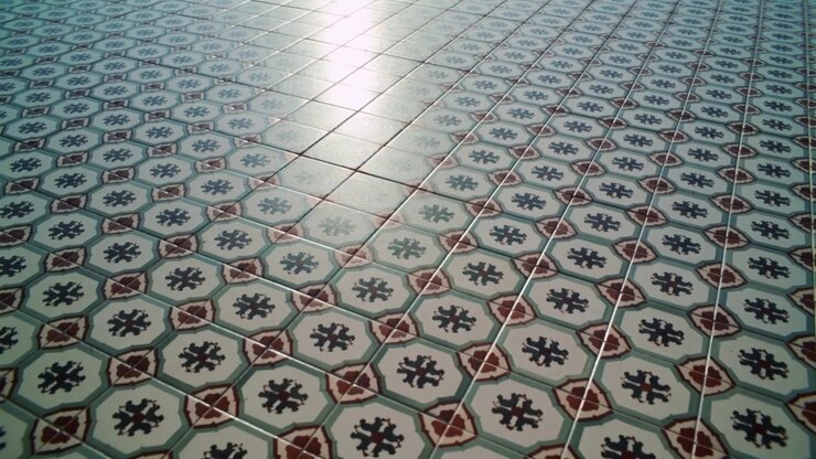 Shifting patterned tiles revealing octagonal motifs and red diamonds inside room, sunlight shifting