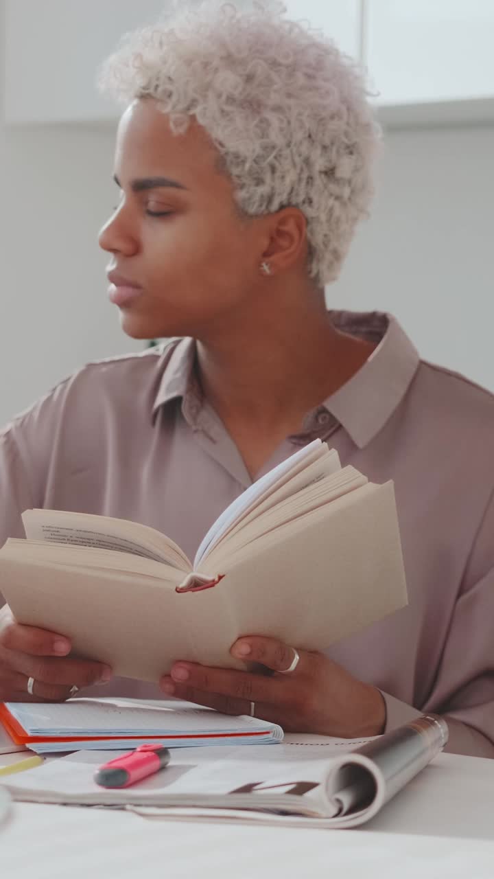 Engaging study session with focused reading in a bright space