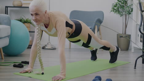 senior woman doing plank exercise at home