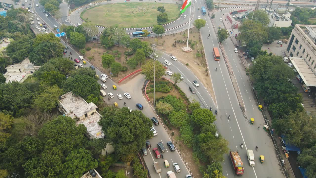 Aerial drone shot highlighting the movement of vehicles on a Delhi flyover, with headlights and taillights forming streaks of light.