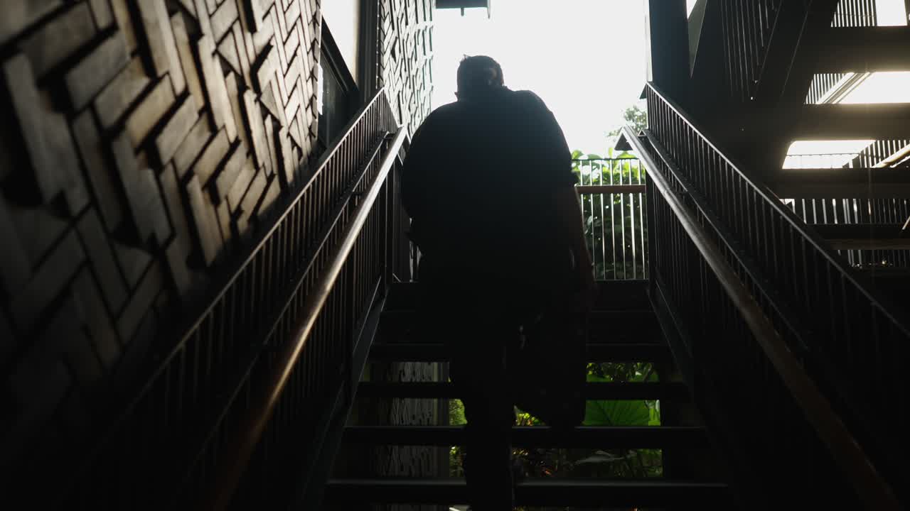 Silhouetted Person Ascending Stairs