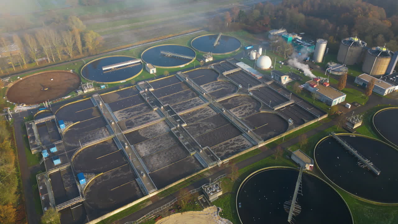 Aerial view orbiting waste water sewage treatment plant sewerage aeriation processing channels