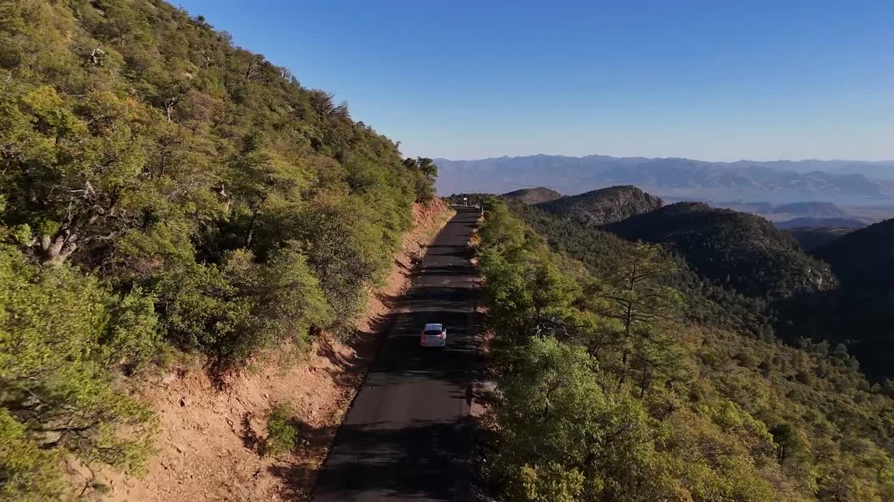 Driving Down Forest Road, Steep drop off, trees and bushes, Valley in background, aerial view, From Desert to Tall Pines Scenic Byway, State Route 288 from Roosevelt Lake to Young Arizona