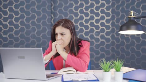 joven mujer de negocios mirando la computadora portátil frustrada, triste e indefensa.