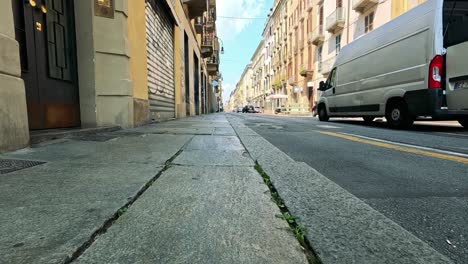 quiet urban street with passing vehicles